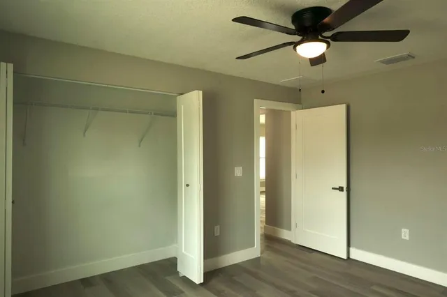 a view of an empty room and wooden floor