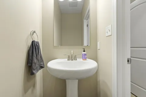 a bathroom with a sink mirror and a shower