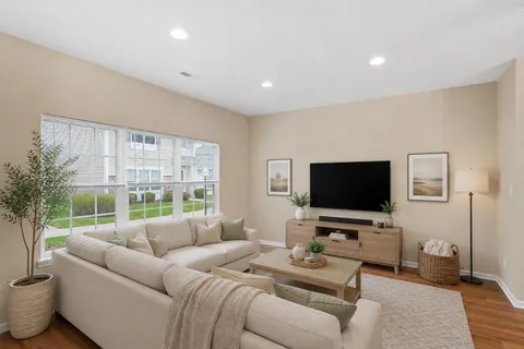a living room with furniture and wooden floor