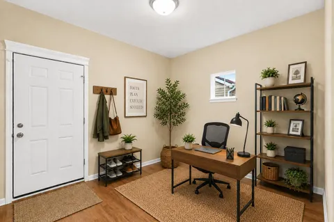a kitchen with stainless steel appliances granite countertop a kitchen island hardwood floor sink stove dining table and chairs