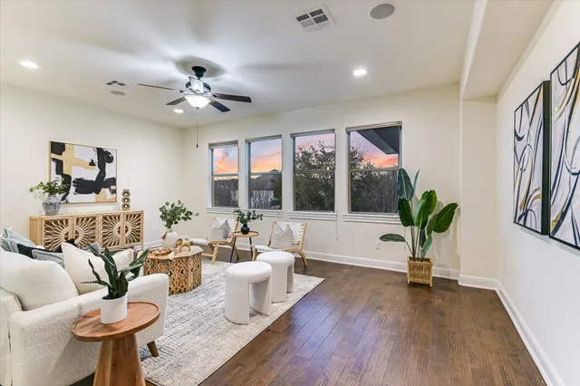 a spacious bedroom with a balcony a bed and a flat screen tv