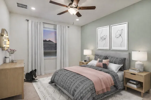 a bedroom with a large bed and a window