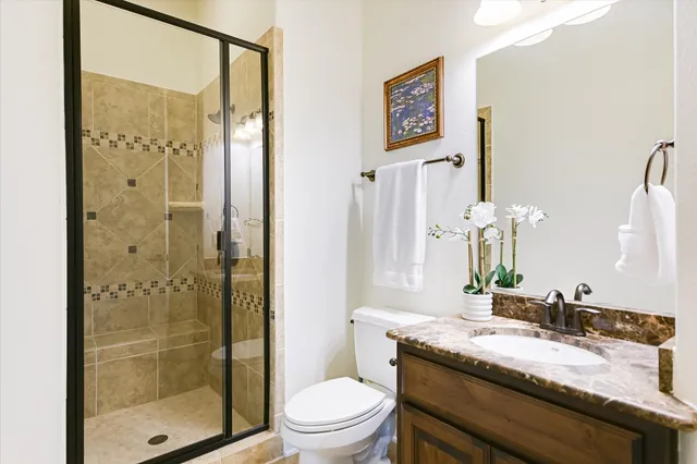 a view of a house with a big yard plants and large trees
