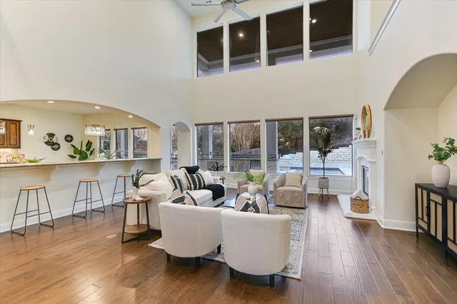 a kitchen with stainless steel appliances granite countertop a stove a sink a refrigerator and chairs