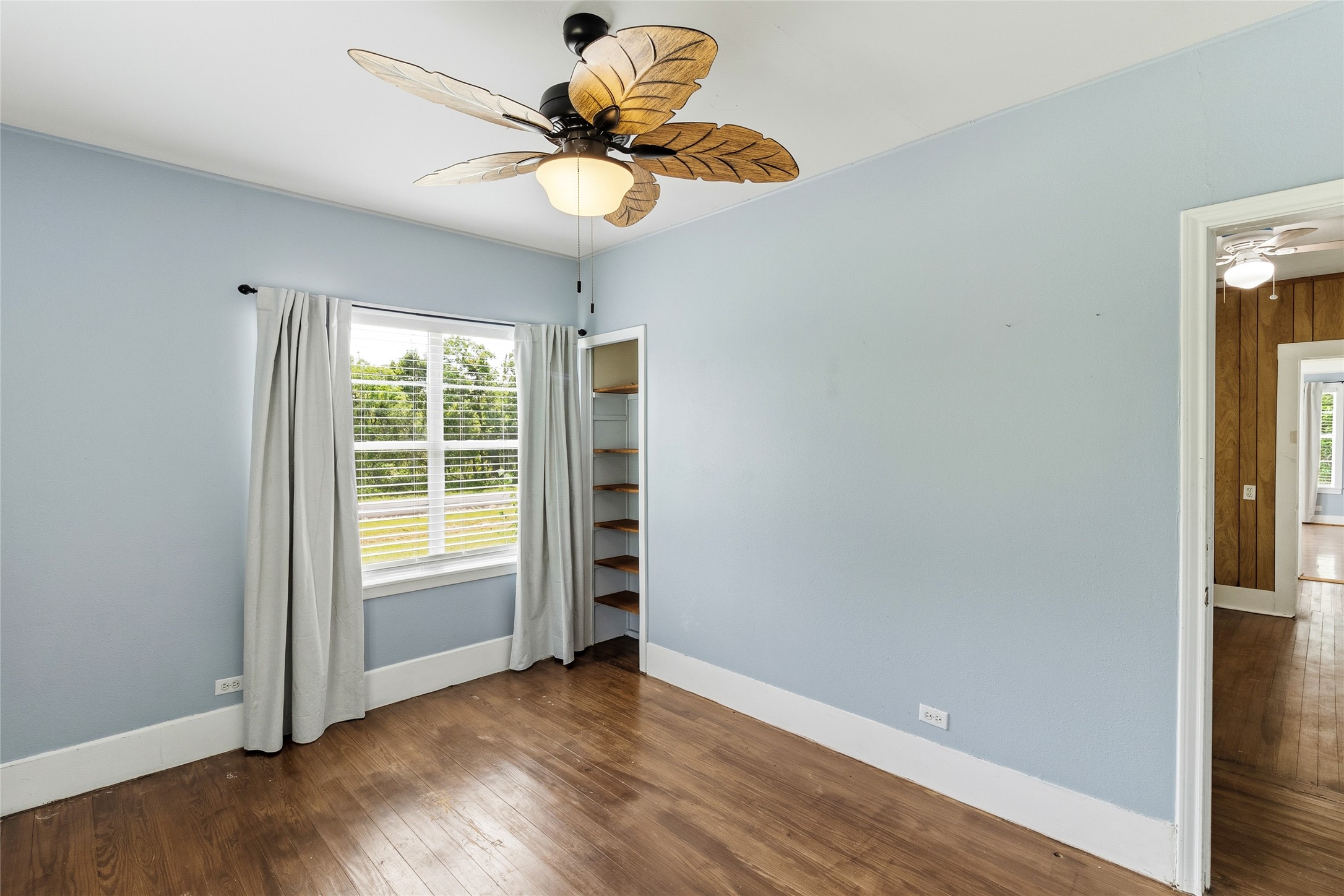 12903 Sandpiper Road Angleton, TX 77515 - Photo 15 of 19 This bedroom (13x10) features original hardwood floors, abundant natural light, and built-in shelving for added storage and display space.