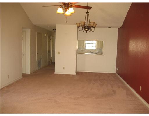 4445 Cedar Pass Drive, Unit 112 Corpus Christi, TX 78413 - Photo 3 of 7 en empty room with windows and ceiling fan