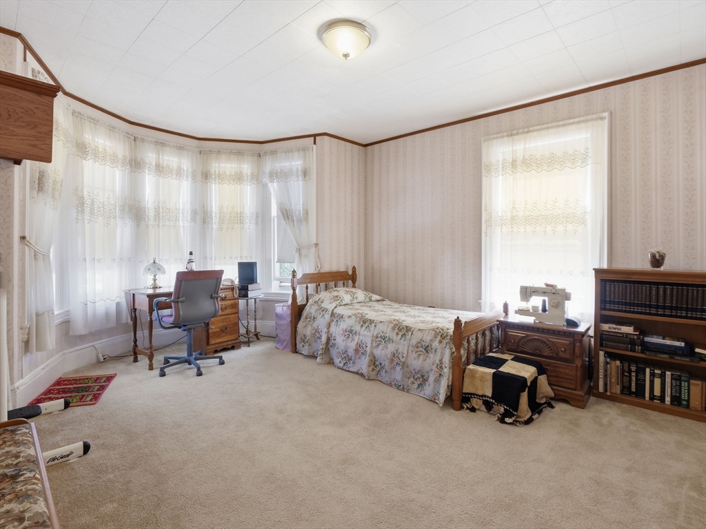 223 Stackpole Street Lowell, MA 01852 - Photo 14 of 42 a bedroom with furniture and a large window
