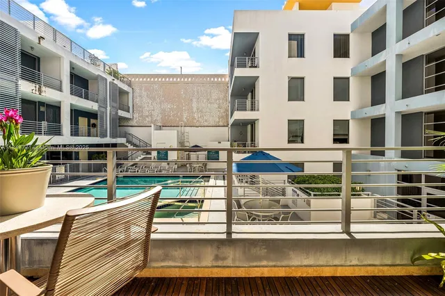 a balcony with table and chairs