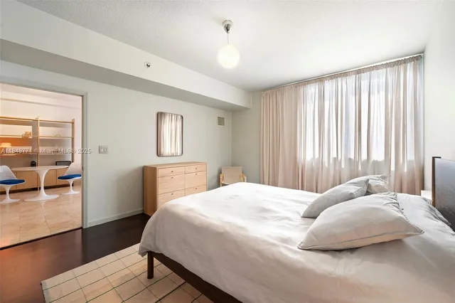 a bedroom with a bed and a night stand