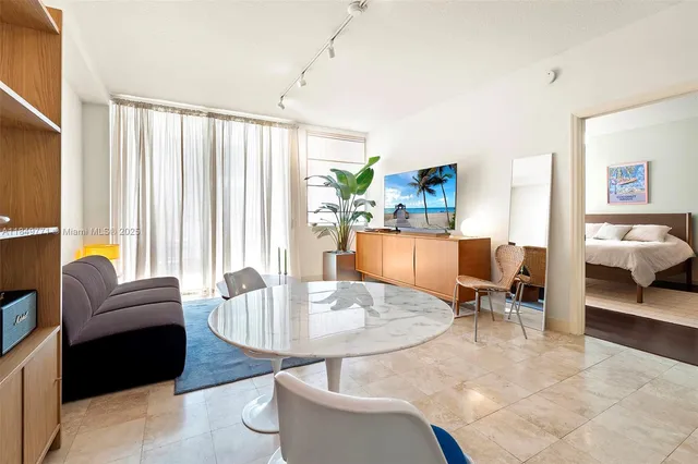 a living room with furniture and a floor to ceiling window