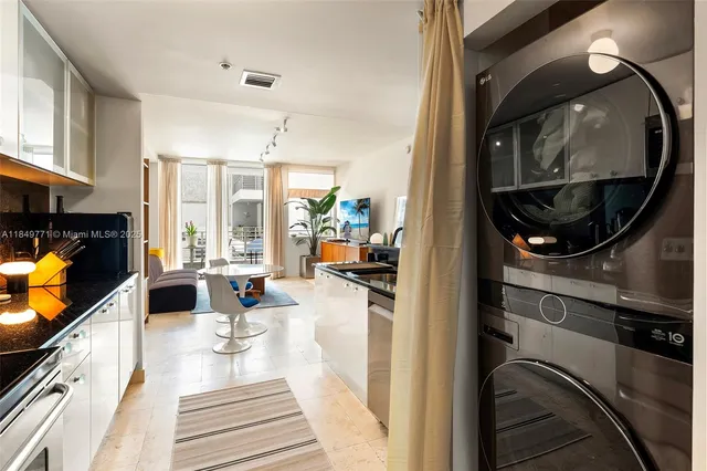 a kitchen with stainless steel appliances granite countertop a refrigerator and a stove