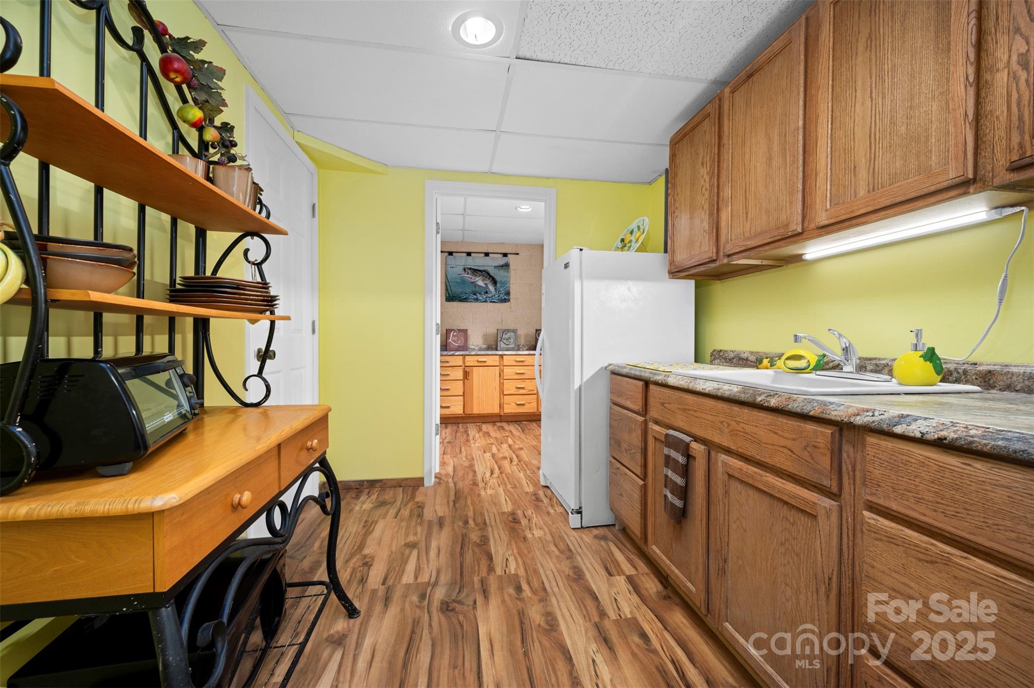 790 County Line Road Rutherfordton, NC 28139 - Photo 24 of 36 a kitchen with stainless steel appliances granite countertop a lot of cabinets a sink and wooden floor
