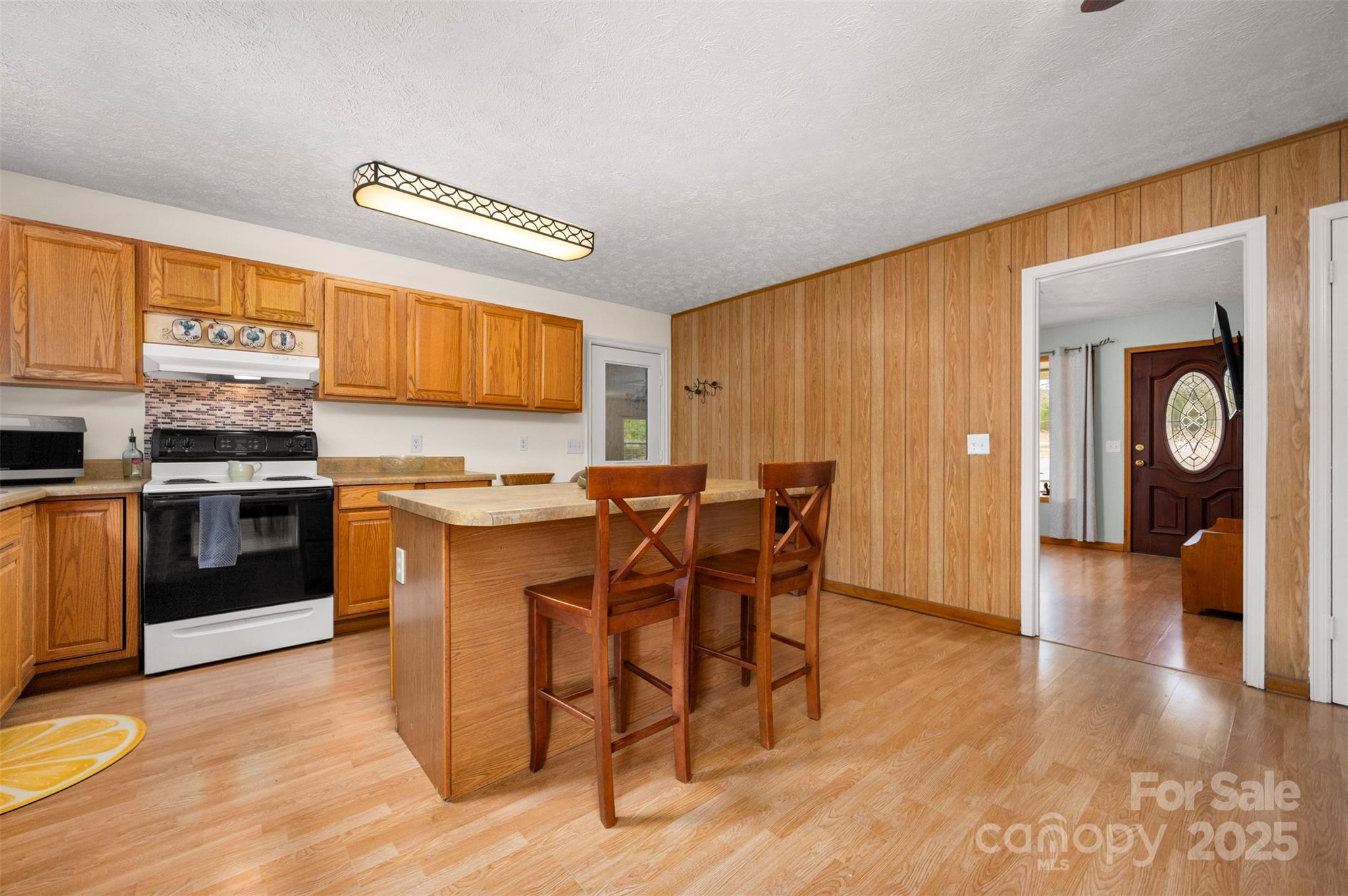 790 County Line Road Rutherfordton, NC 28139 - Photo 7 of 36 a kitchen with stainless steel appliances granite countertop a stove top oven a sink a dining table and chairs with wooden floor