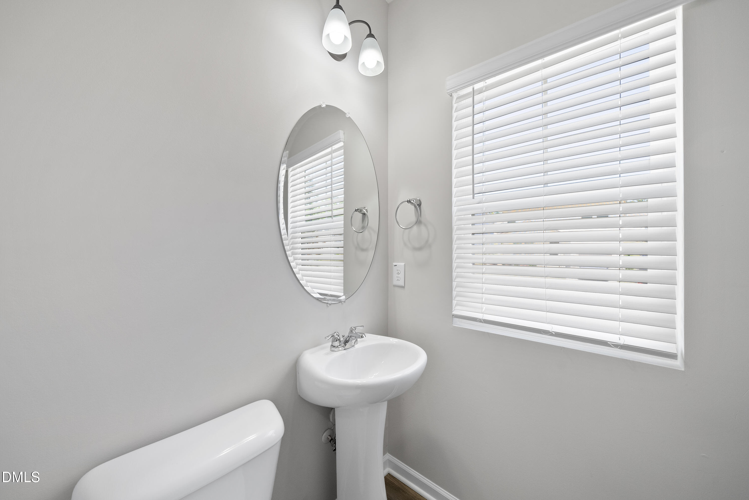 2816 Elsa Drive Raleigh, NC 27610 - Photo 10 of 35 a bathroom with a toilet a sink and a window