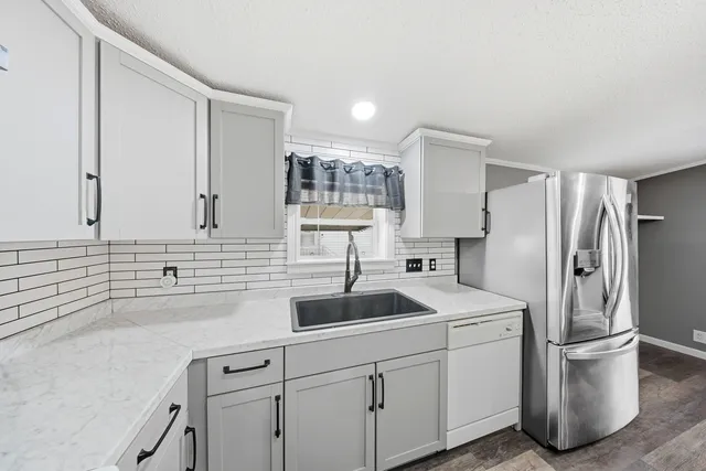 a kitchen with a sink and refrigerator