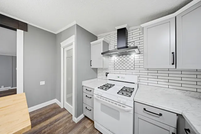 a kitchen with cabinets stove and oven