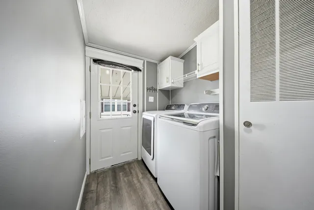 a utility room with cabinets washer and dryer