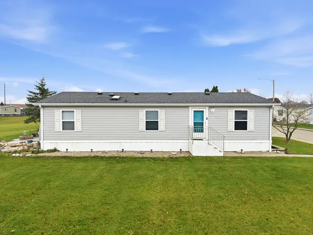 a view of a house with a yard and sitting area