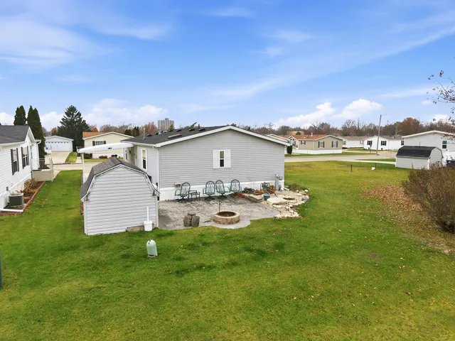 a view of a house with a yard and lake view