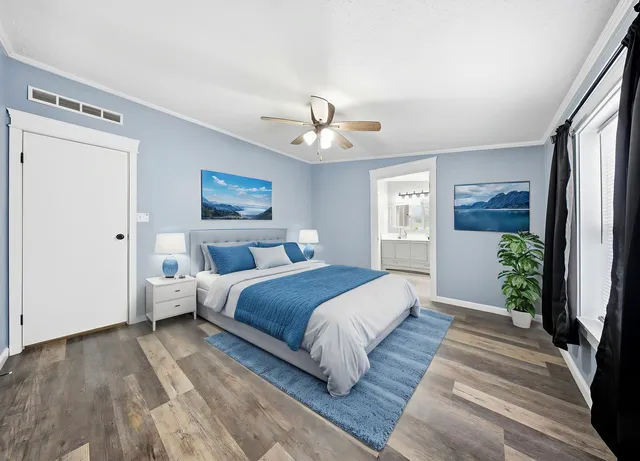 a bedroom with a large bed and a chandelier