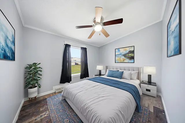 a bedroom with bed and a potted plant