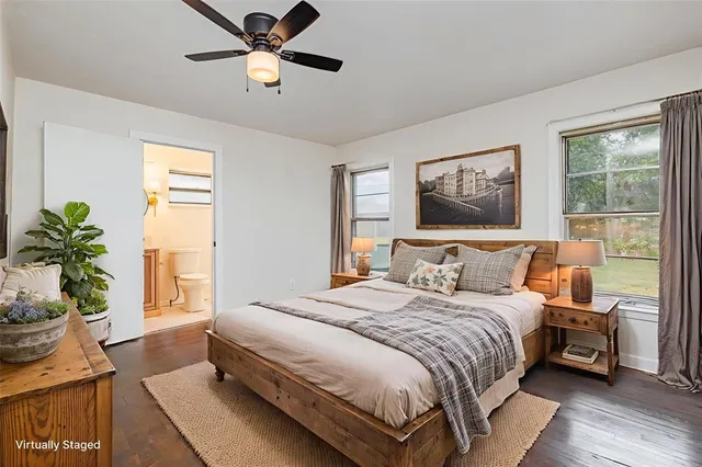 a bedroom with a large bed and a window