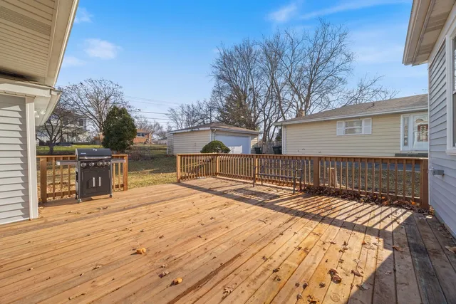 a view of backyard with wooden floor and fence