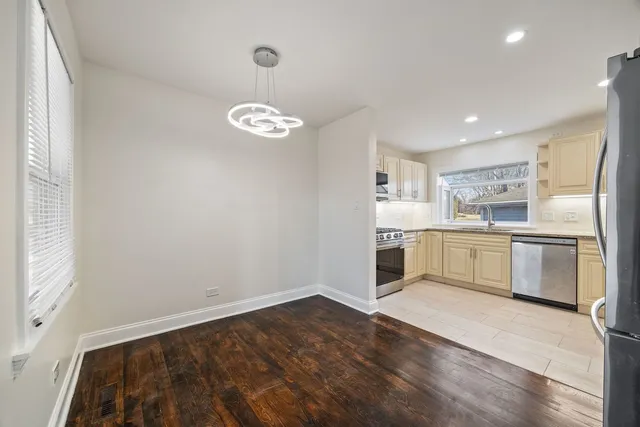 a kitchen with white cabinets and white appliances