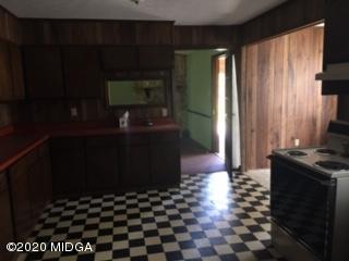 3623 Tidwell Road Lizella, GA 31052 - Photo 11 of 12 a kitchen with a black white checkered floor