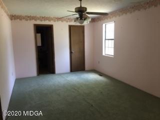 3623 Tidwell Road Lizella, GA 31052 - Photo 6 of 12 an empty room with windows and fan