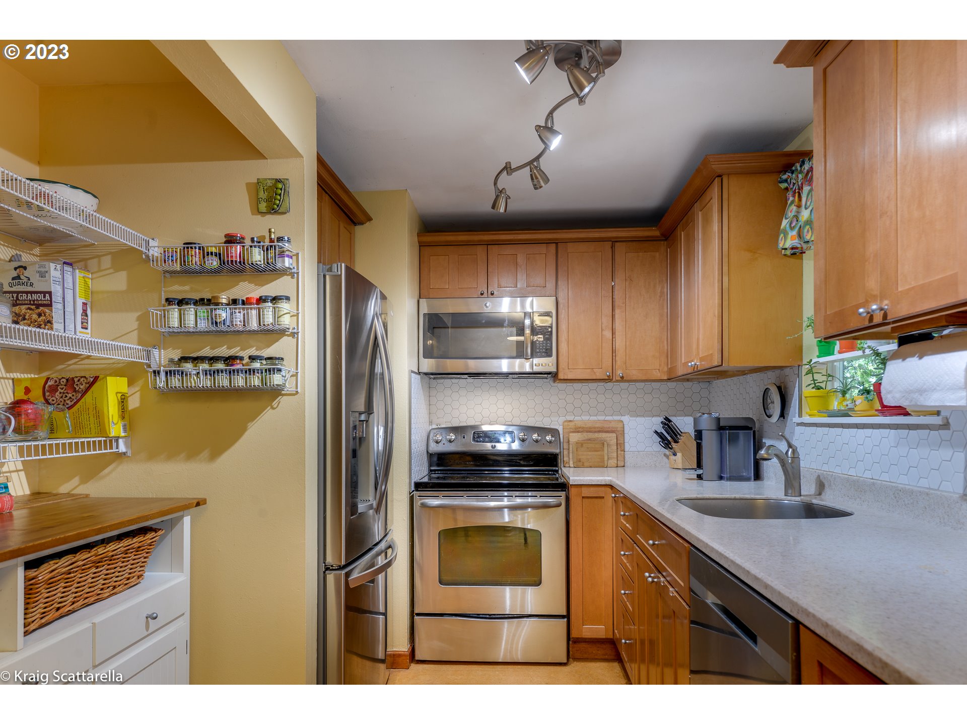 5109 Southwest Boundary Street Portland, OR 97221 - Photo 2 of 20 a kitchen with stainless steel appliances a stove a sink and a refrigerator