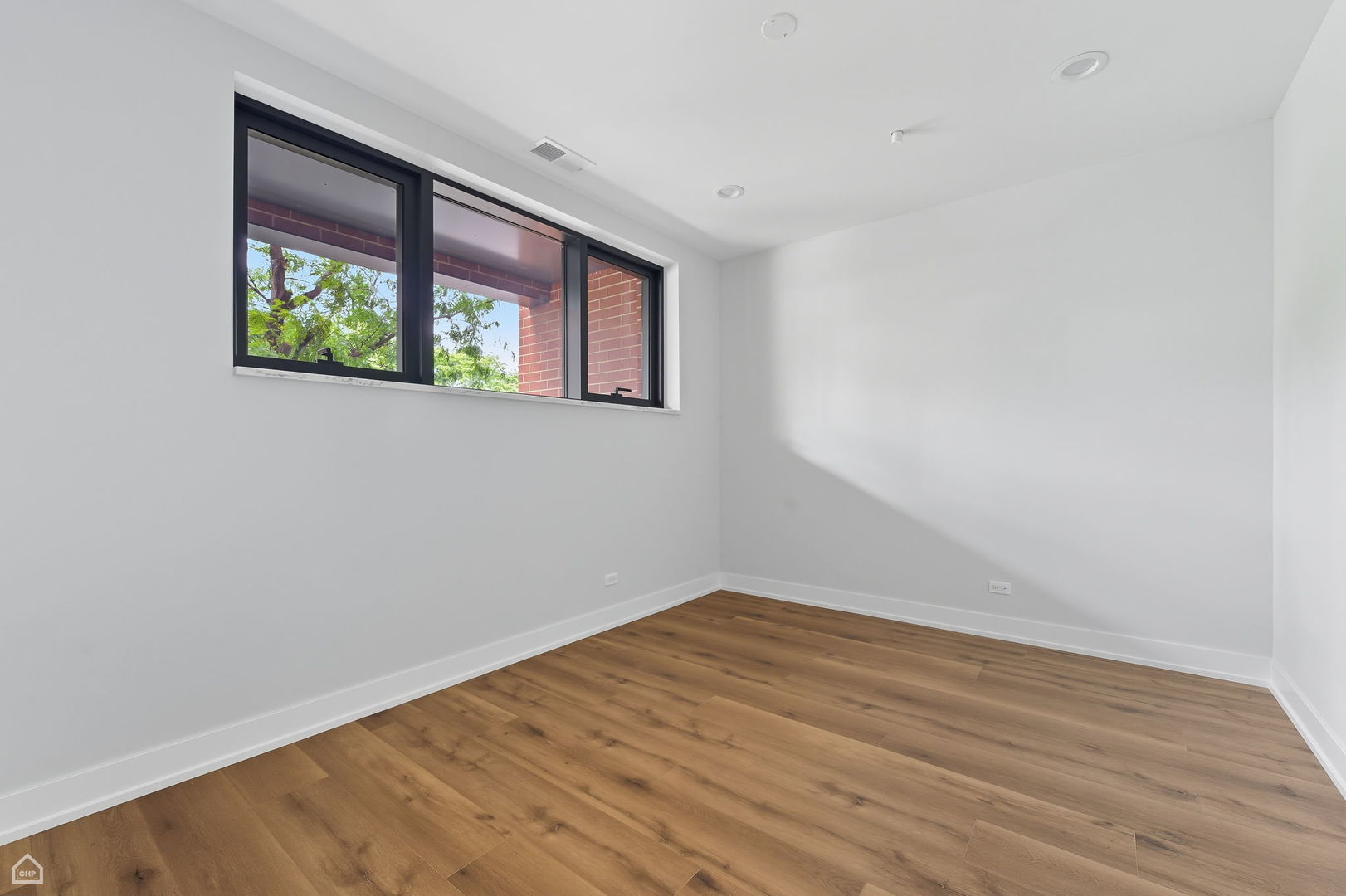 2354 North Washtenaw Avenue, Unit 304 Chicago, IL 60647 - Photo 11 of 16 wooden floor in an empty room