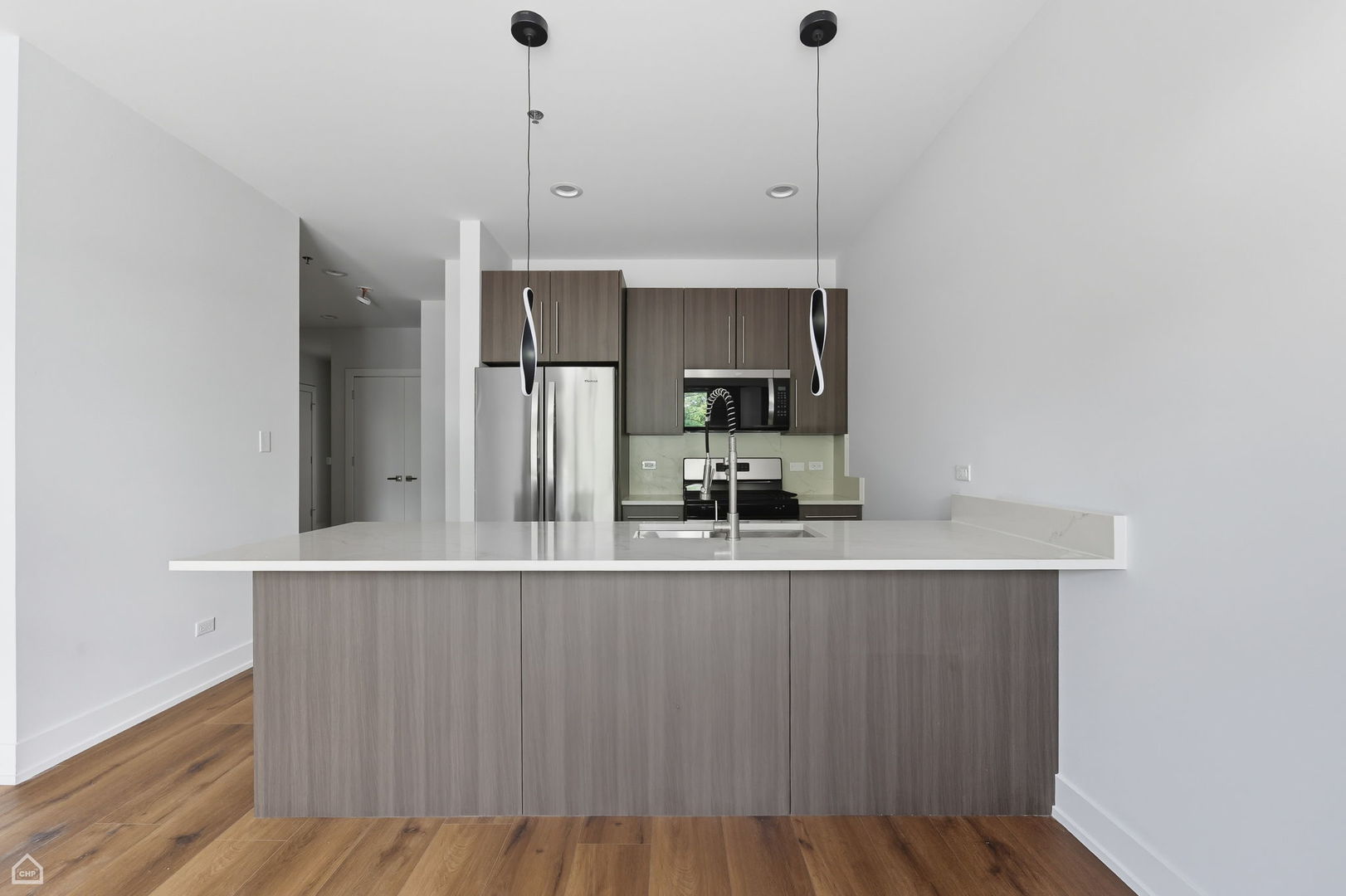 2354 North Washtenaw Avenue, Unit 304 Chicago, IL 60647 - Photo 3 of 16 a kitchen with kitchen island a counter top space appliances and cabinets