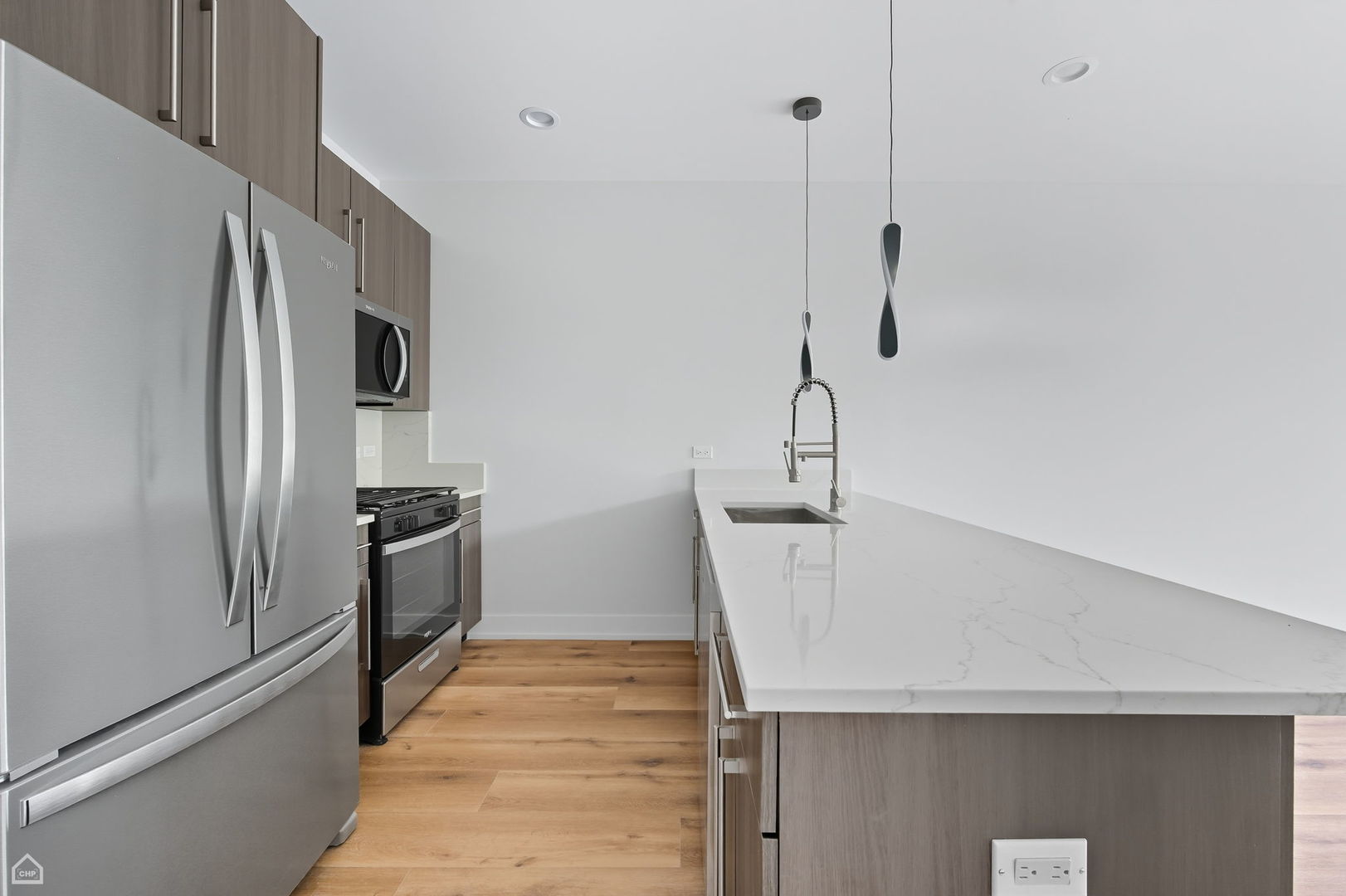 2354 North Washtenaw Avenue, Unit 304 Chicago, IL 60647 - Photo 4 of 16 a kitchen with stainless steel appliances a refrigerator and a sink
