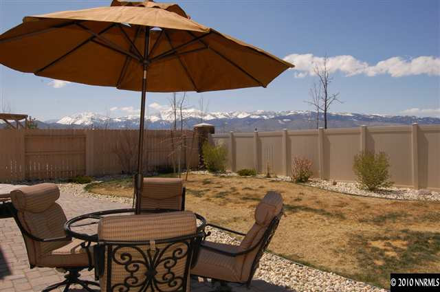 2175 Evergreen Park Drive Reno, NV 89521 - Photo 9 of 9 a patio with a table and chairs under an umbrella