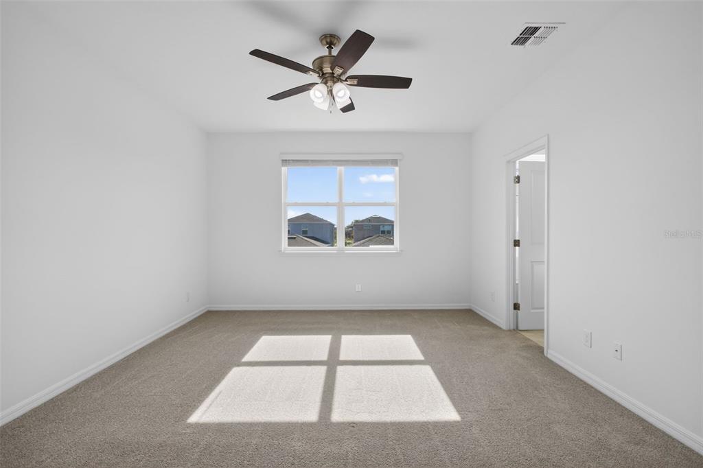 810 MIDDLETON Street DeBary, FL 32713 - Photo 25 of 52 an empty room with a window and a ceiling fan