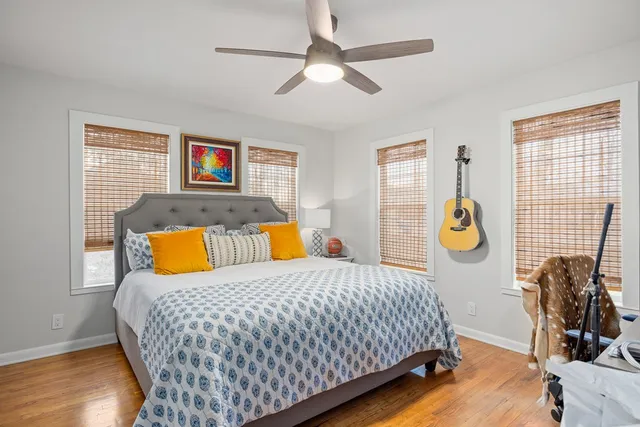 a bedroom with a bed and wooden floor