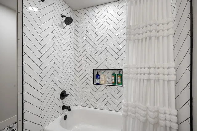 a bathroom with a bathtub and shower