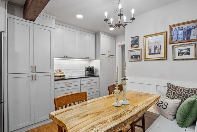 a kitchen with a table chairs and refrigerator