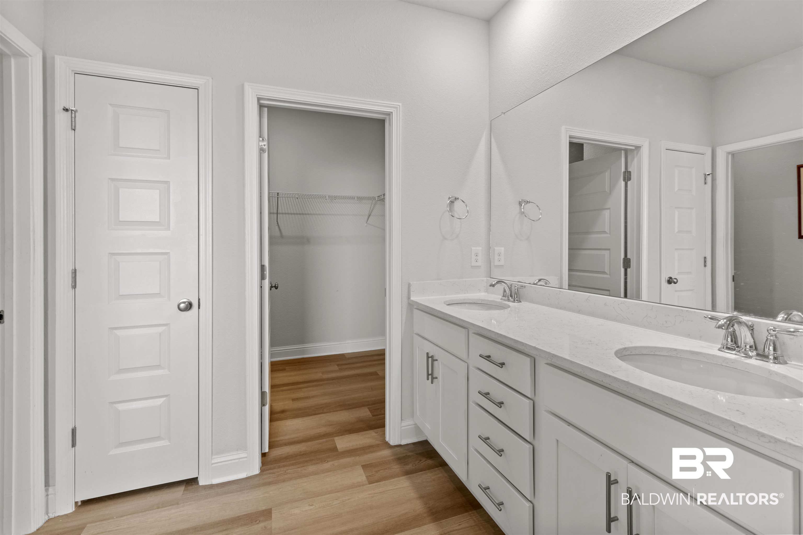 485 Shepard Street Gulf Shores, AL 36542 - Photo 22 of 53 Primary bathroom featuring double vanity, light wood-style floors, and a spacious closet