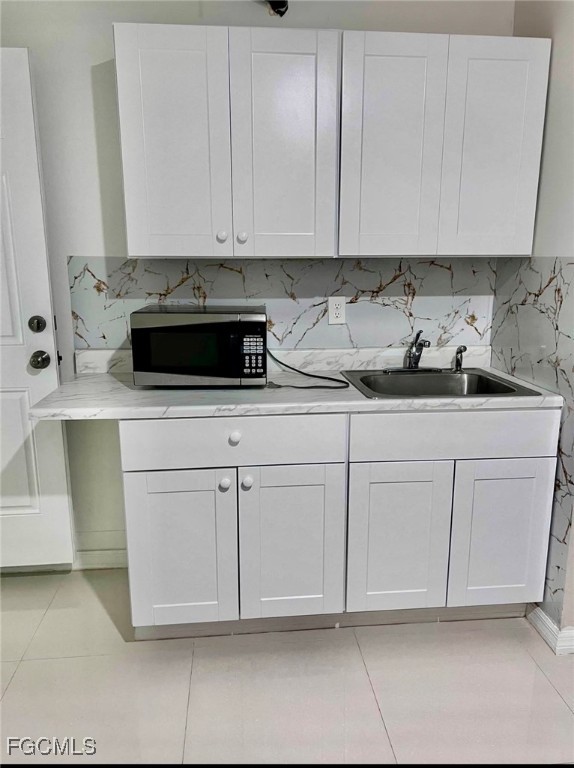 2209-2211 Park Road Lehigh Acres, FL 33971 - Photo 4 of 7 a kitchen with white cabinets and white appliances
