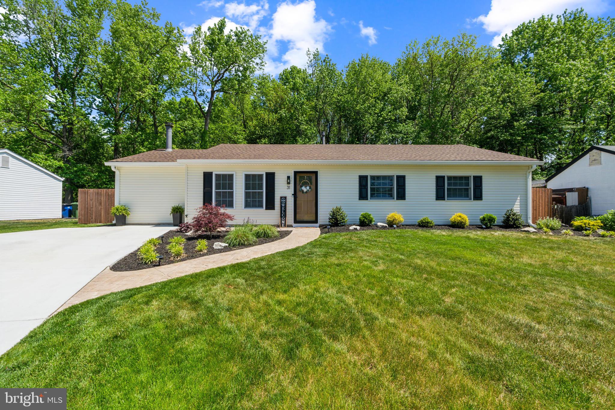 a view of a house with a backyard and a patio
