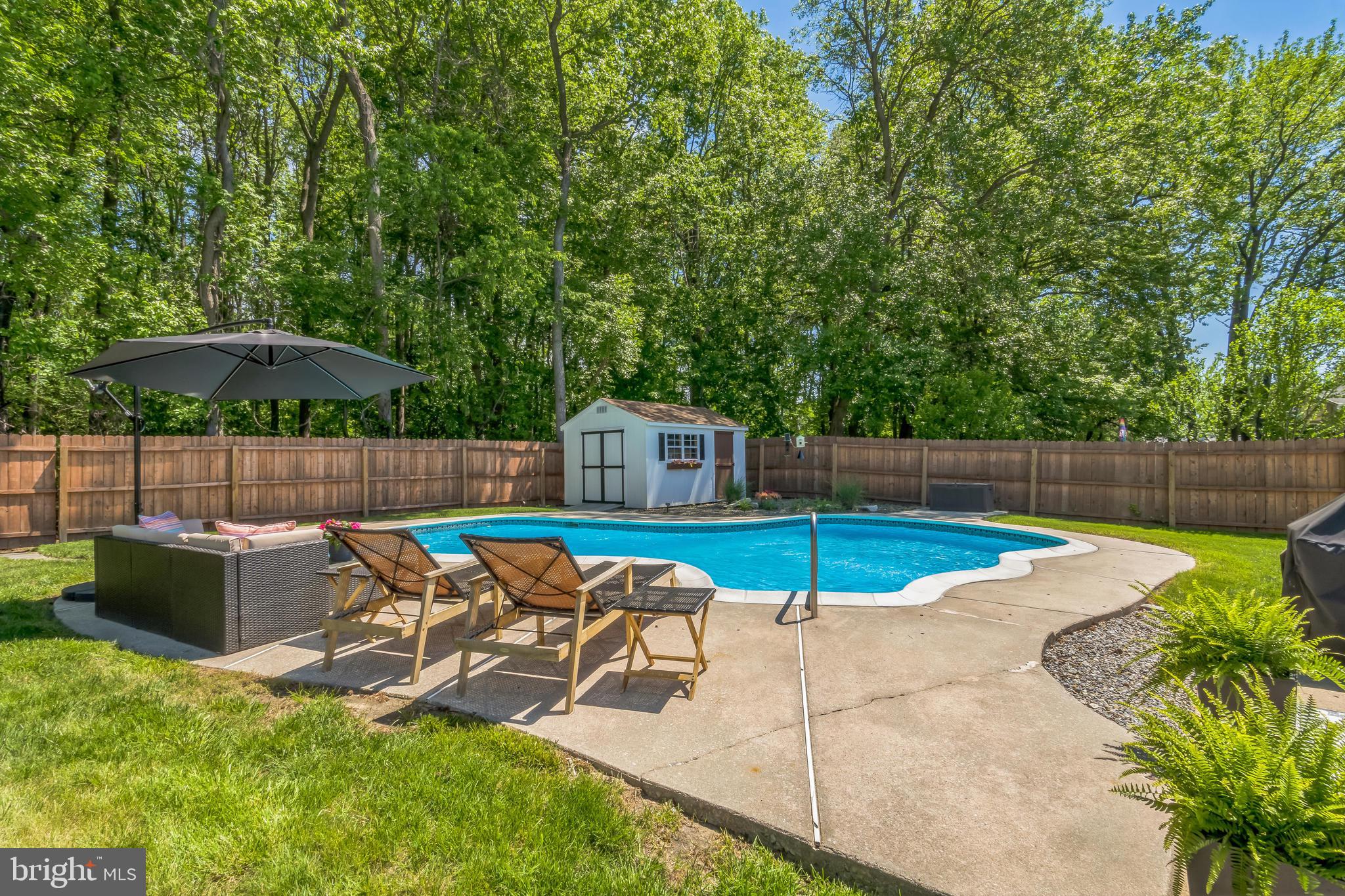 31 Hanover Road Marlton, NJ 08053 - Photo 14 of 15 a view of a patio with table and chairs potted plants with wooden fence