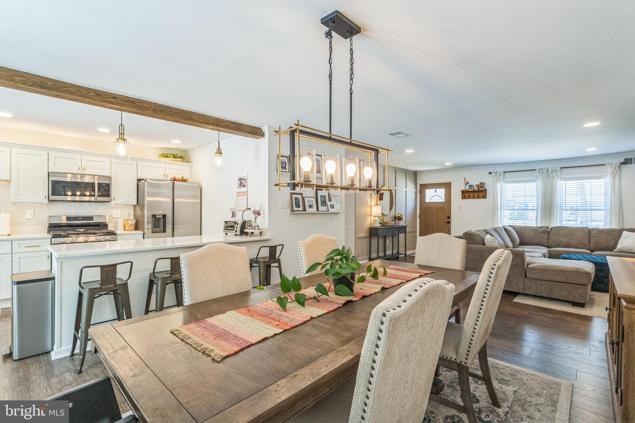 31 Hanover Road Marlton, NJ 08053 - Photo 5 of 15 a view of a dining room and livingroom with furniture wooden floor a chandelier