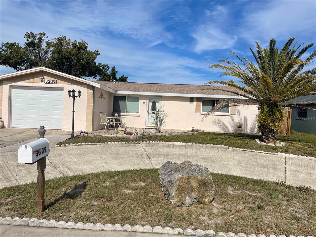 3309 Chauncy Road Holiday, FL 34691 - Photo 1 of 1 a front view of a house with garden