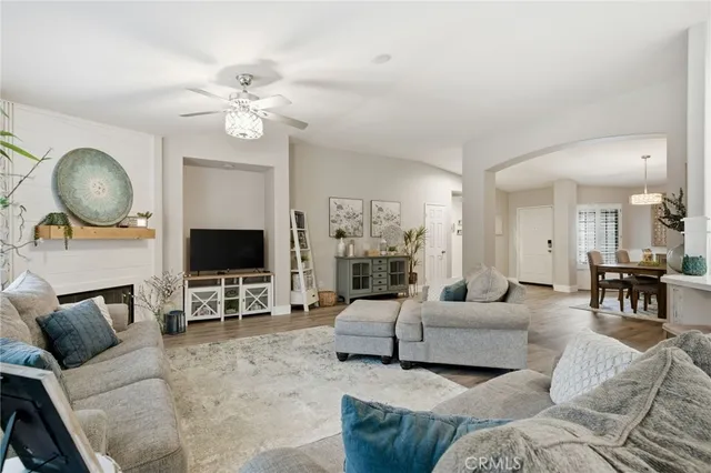 a living room with furniture a fireplace and a flat screen tv