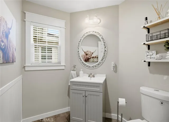a bathroom with a toilet a sink and a mirror