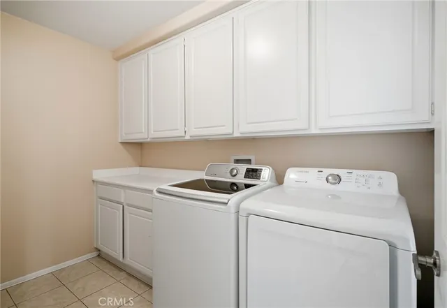 a view of storage and utility room with washer and dryer