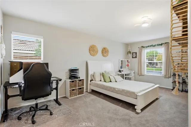 a bedroom with a bed and a chair