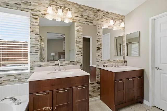 a bathroom with a sink double vanity and a mirror